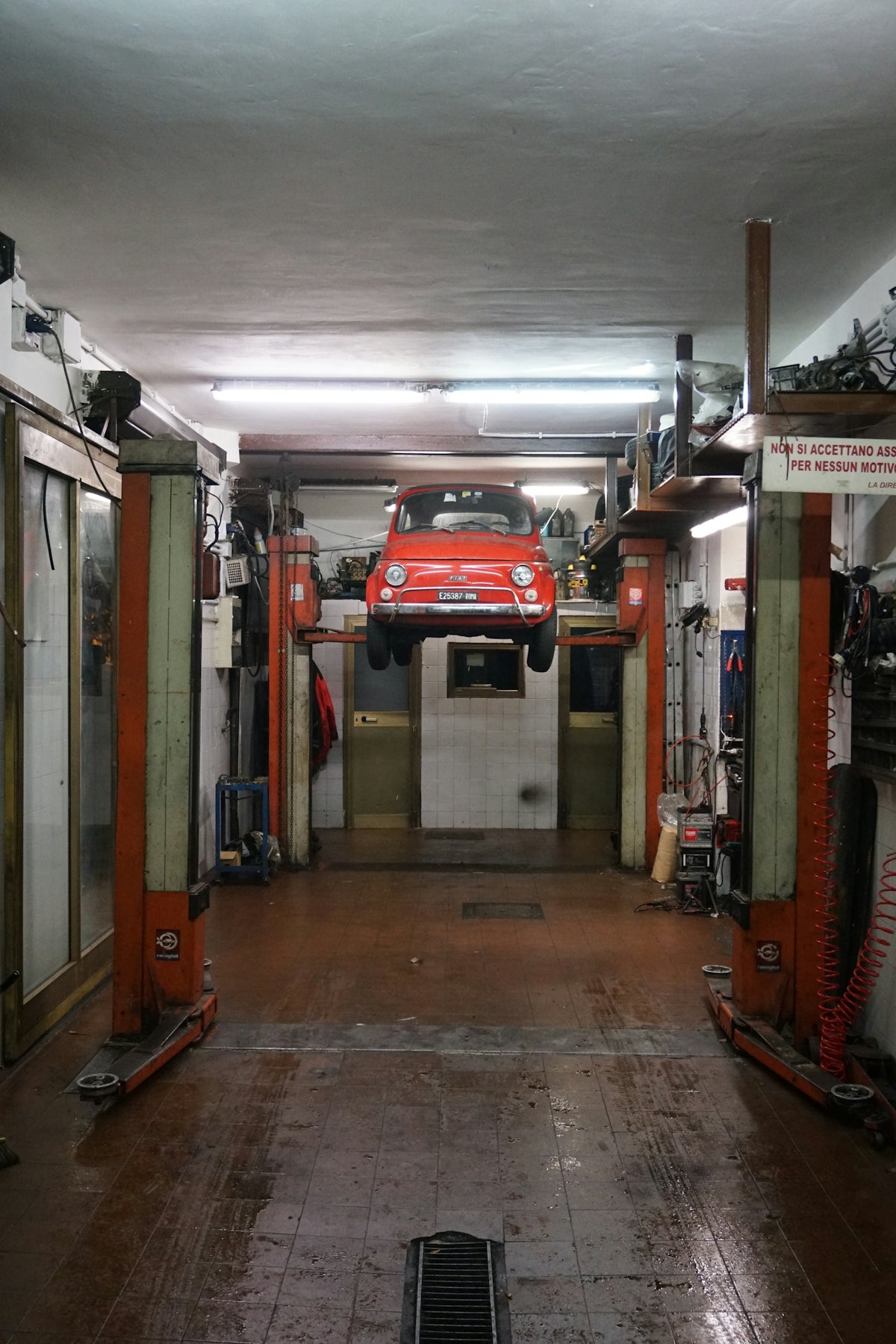 red Abarath vehicle on lift