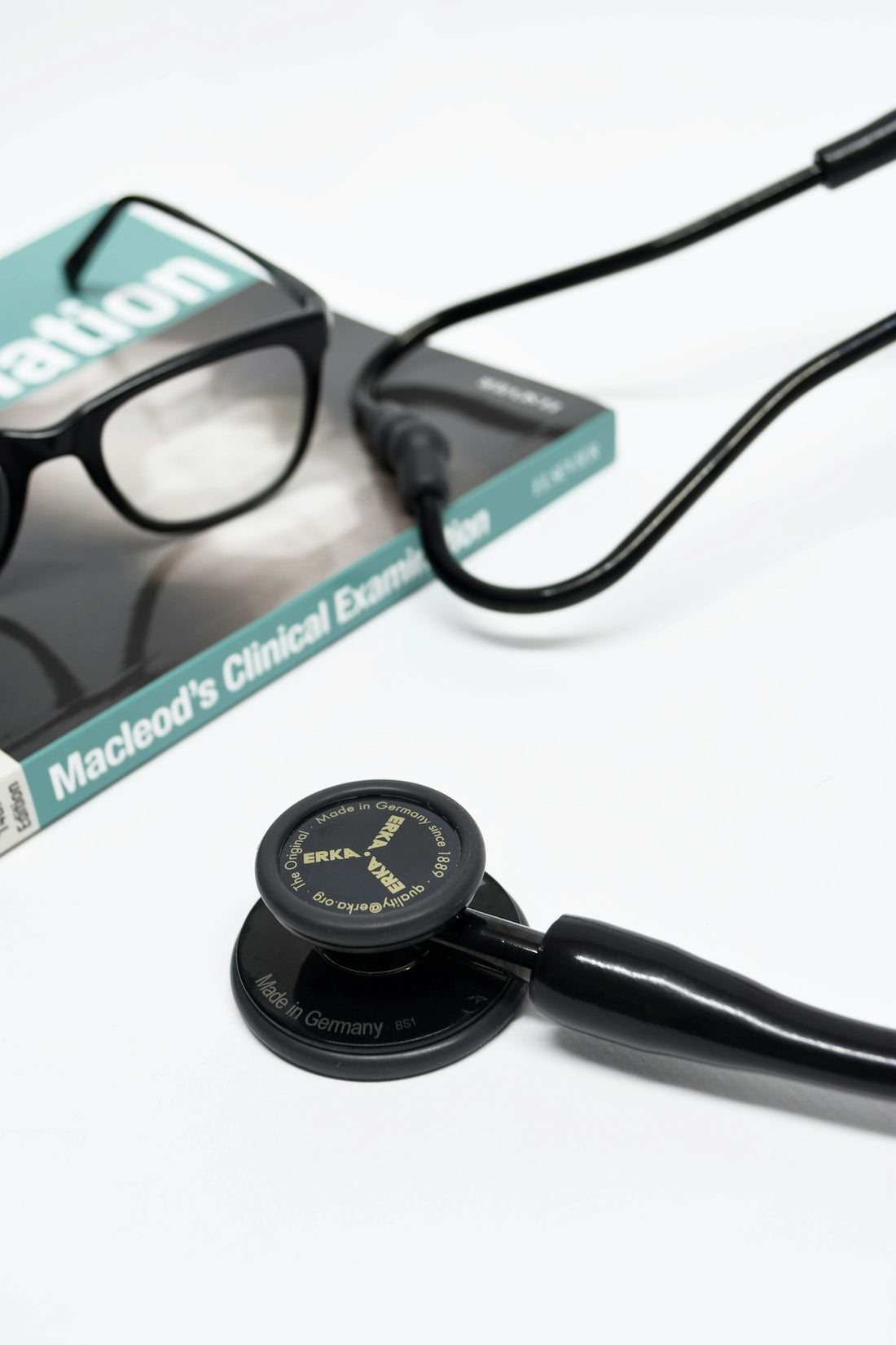black stethoscope near black framed eyeglasses