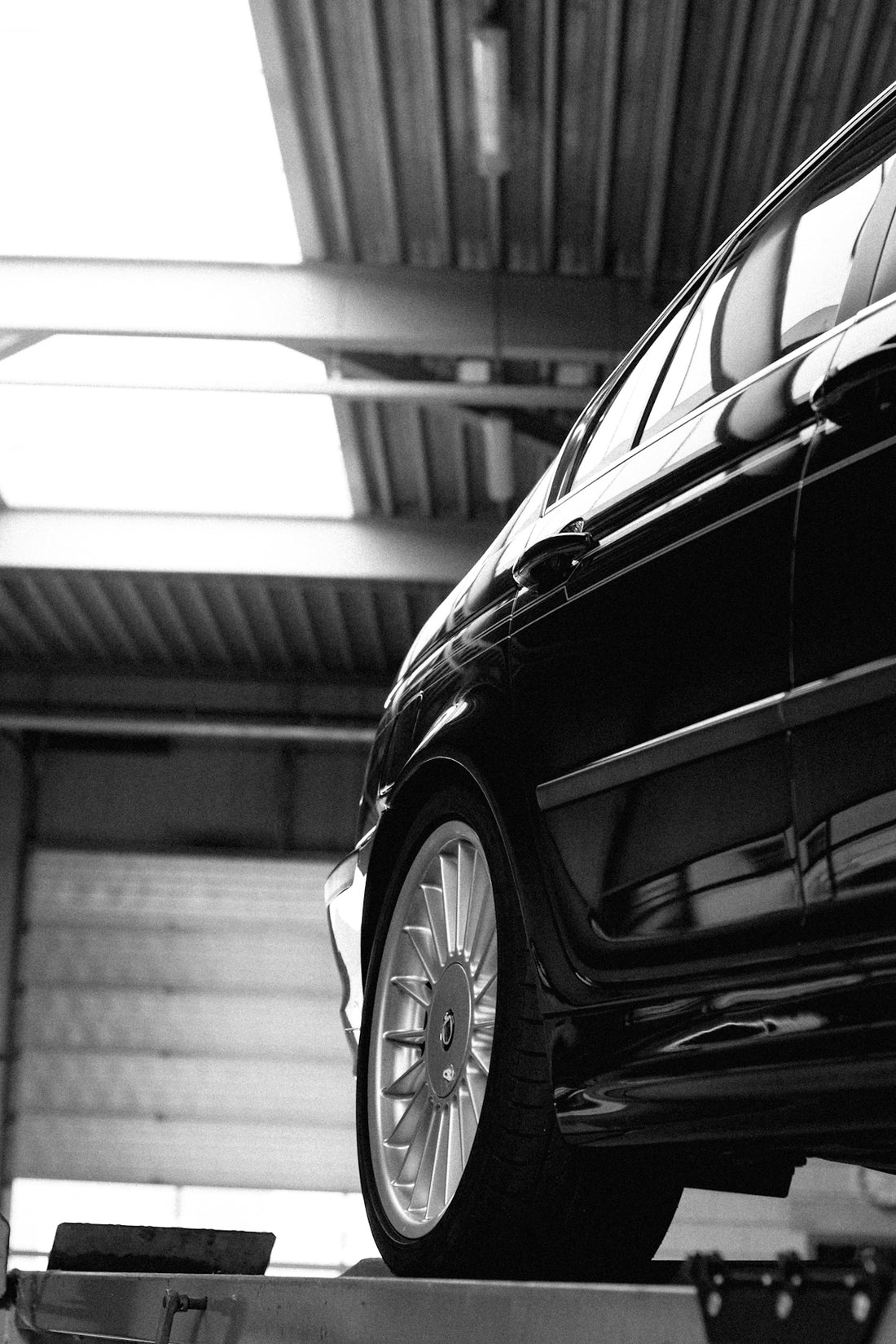 a car on a flatbed in a garage