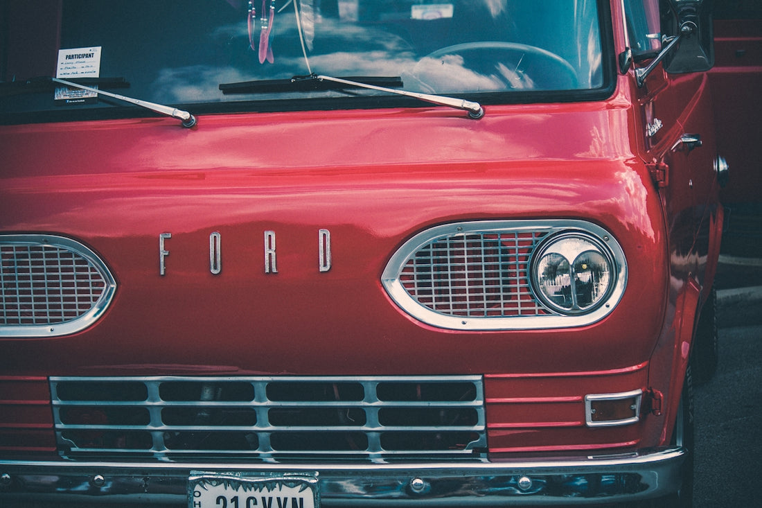 a red ford truck parked in a parking lot