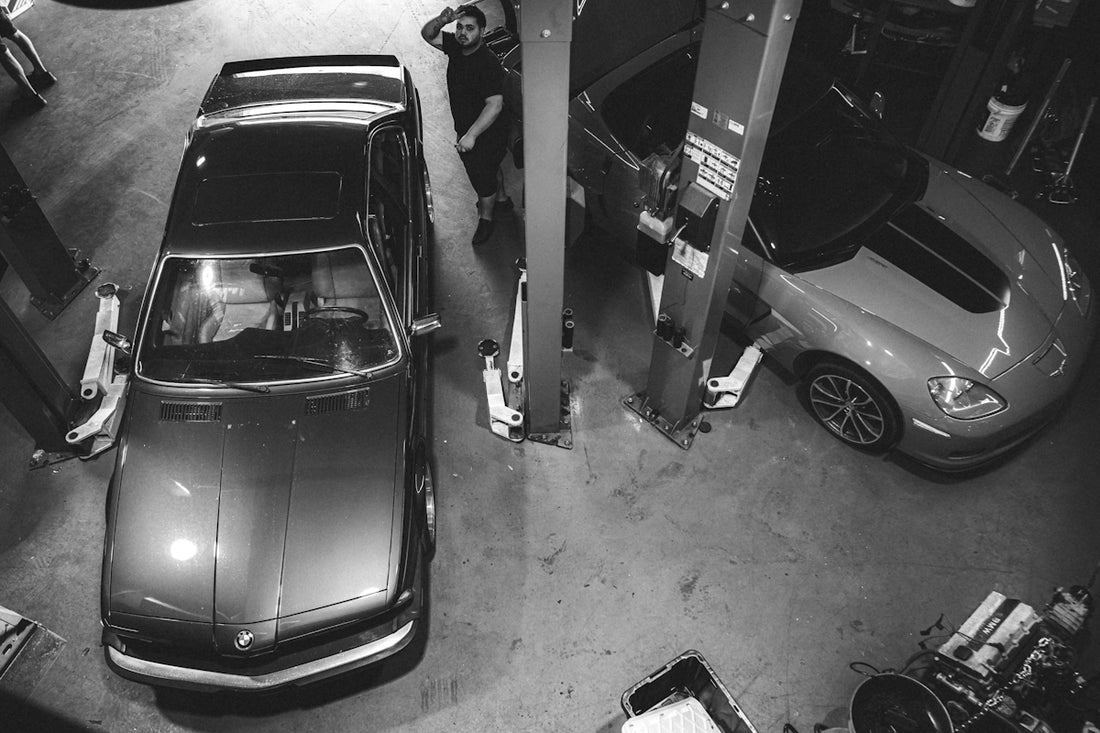 a car parked in a garage next to a gas pump