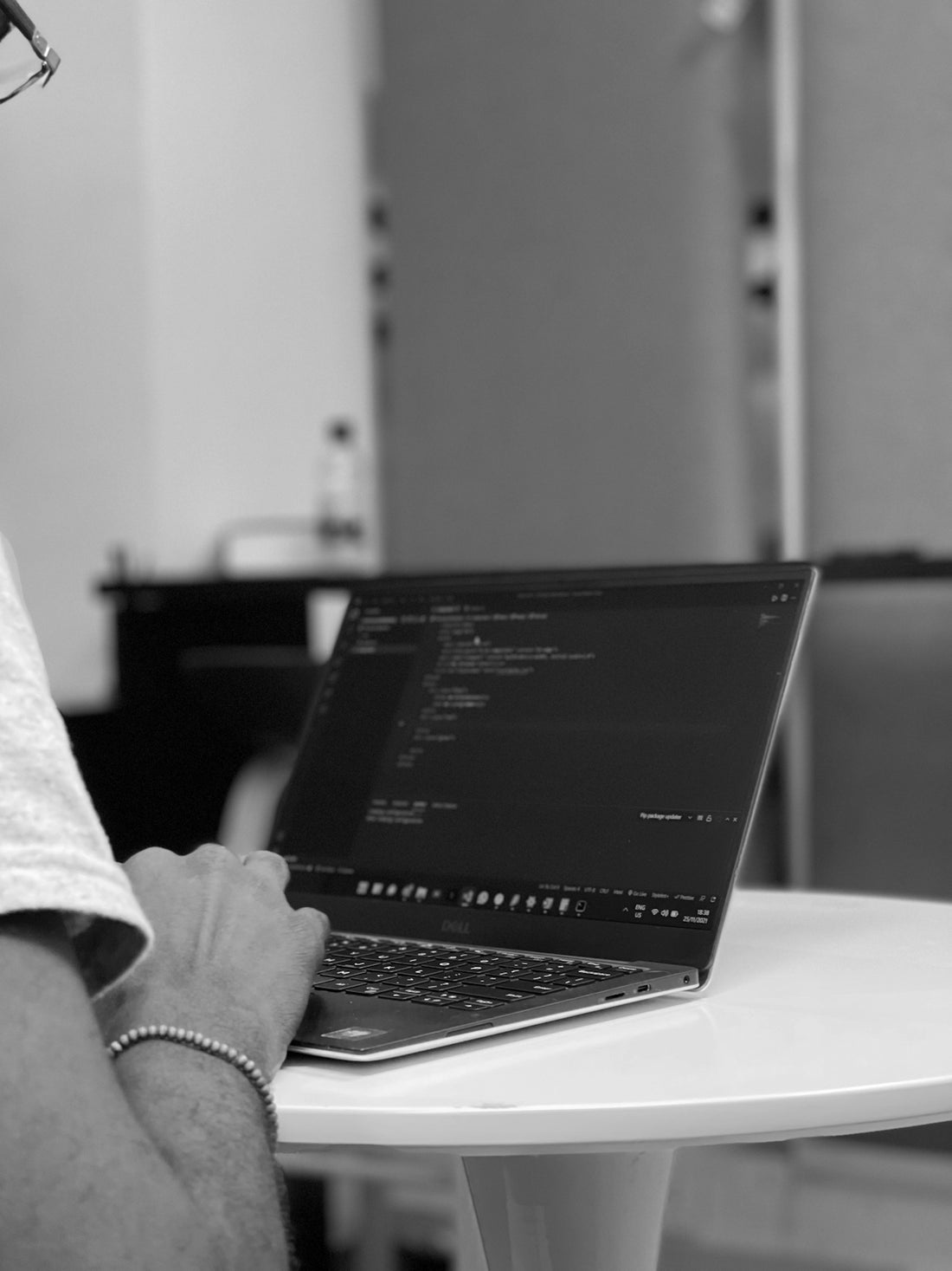 a man sitting at a table using a laptop computer