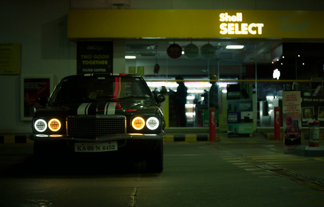a car parked in front of a store at night