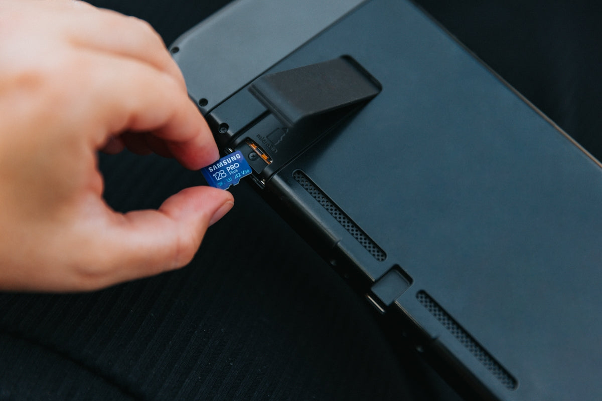 a hand holding a black rectangular object