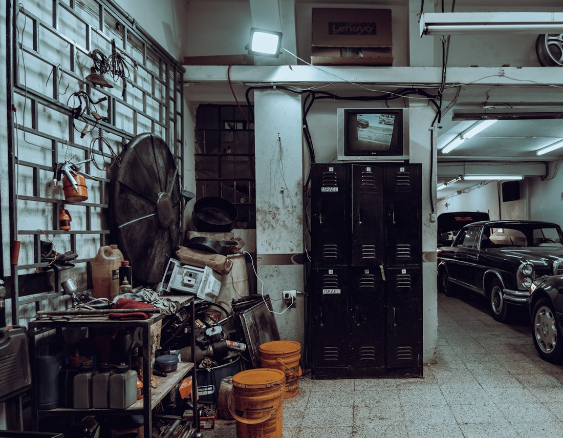 a garage filled with lots of junk and old cars