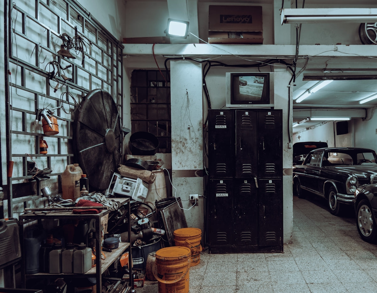 a garage filled with lots of junk and old cars