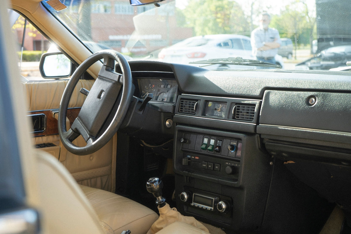 the interior of a car with a dash board and steering wheel