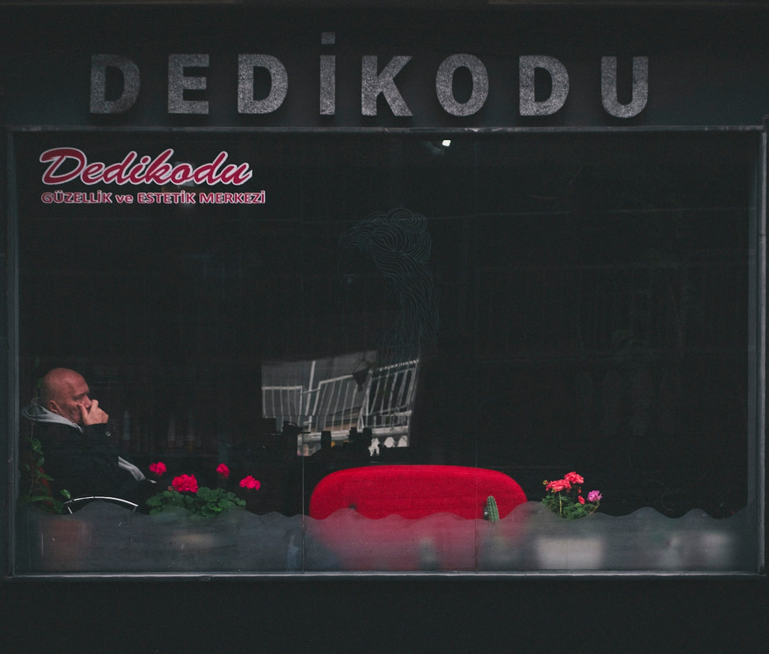 a man sitting in a chair in front of a window