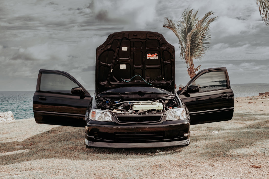a couple of cars parked next to each other on a beach