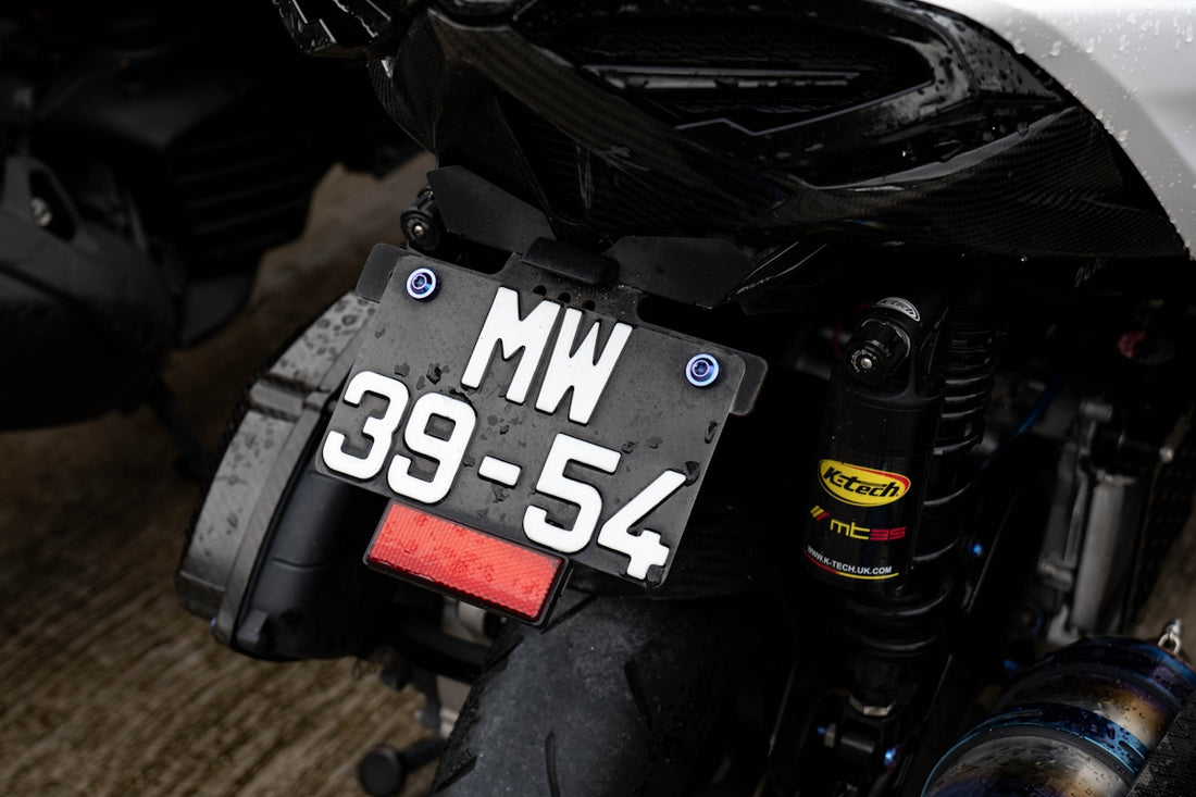 A close up of a motorcycle on a wooden floor