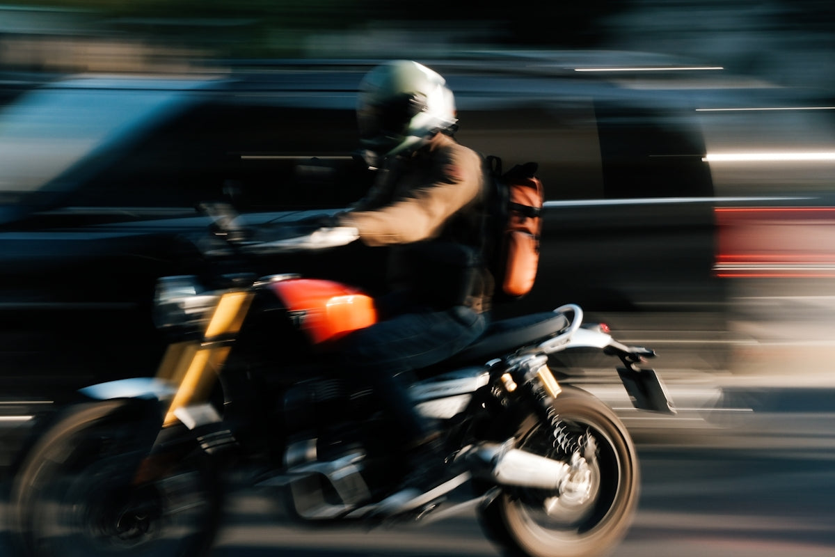 A blurry photo of a person riding a motorcycle
