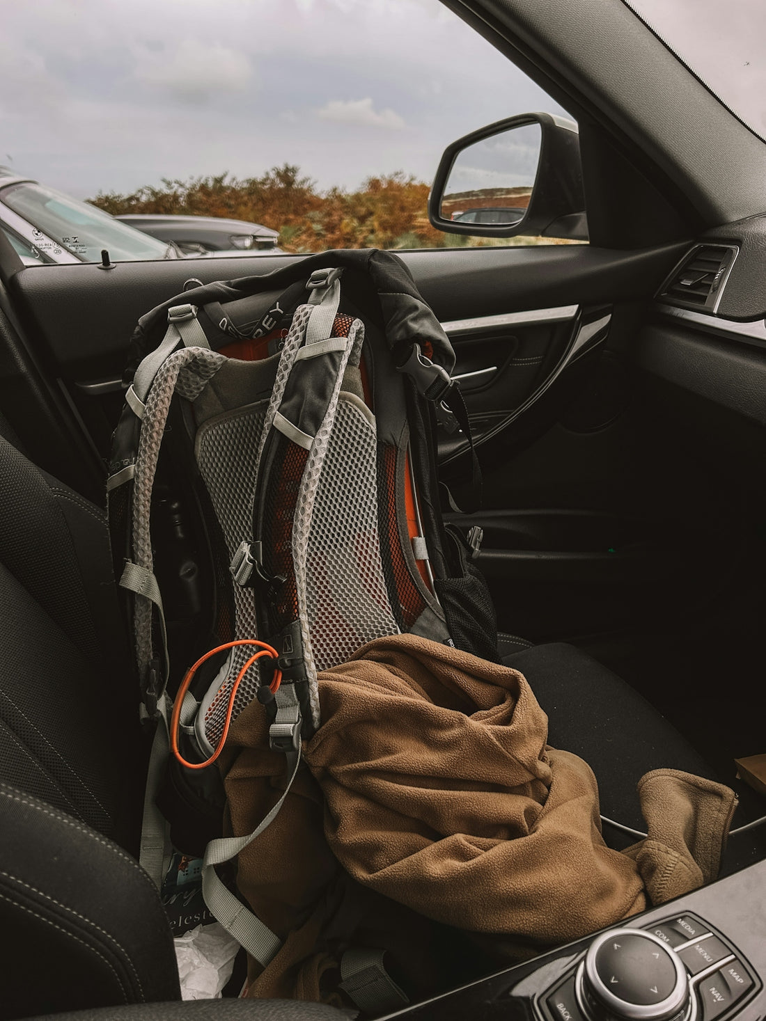 A backpack sitting in the passenger seat of a car