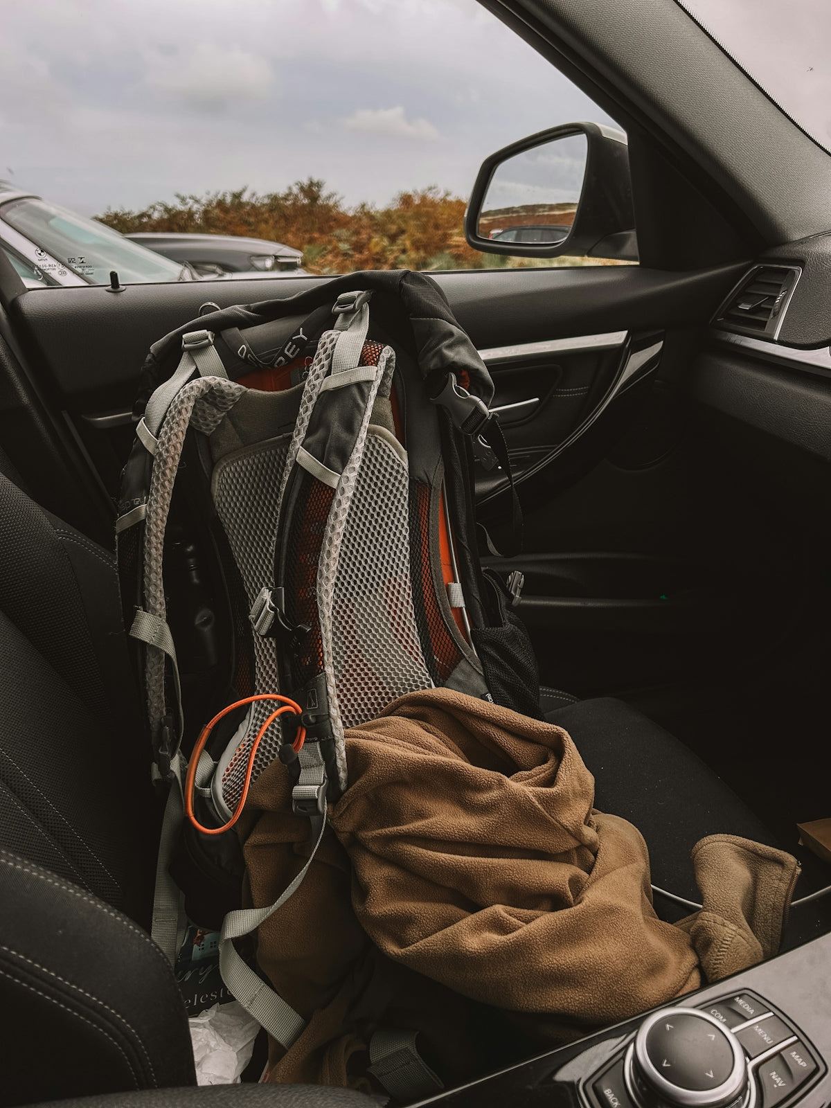 A backpack sitting in the passenger seat of a car