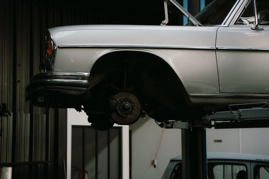A car is on a lift in a garage