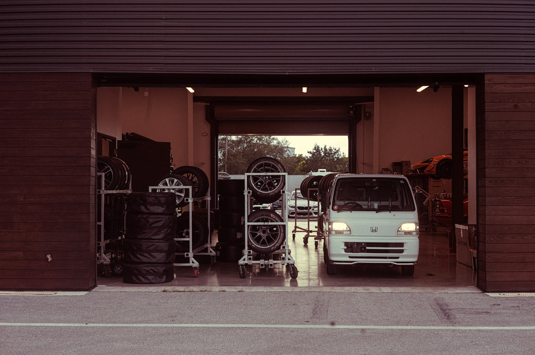 A white van parked in front of a garage