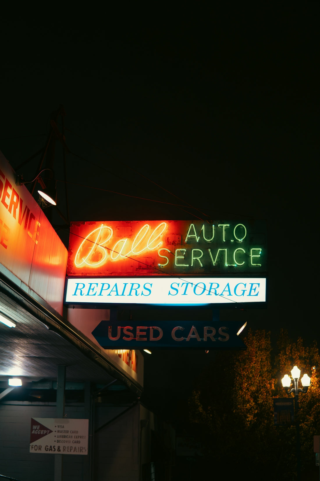 A neon sign for a car repair shop