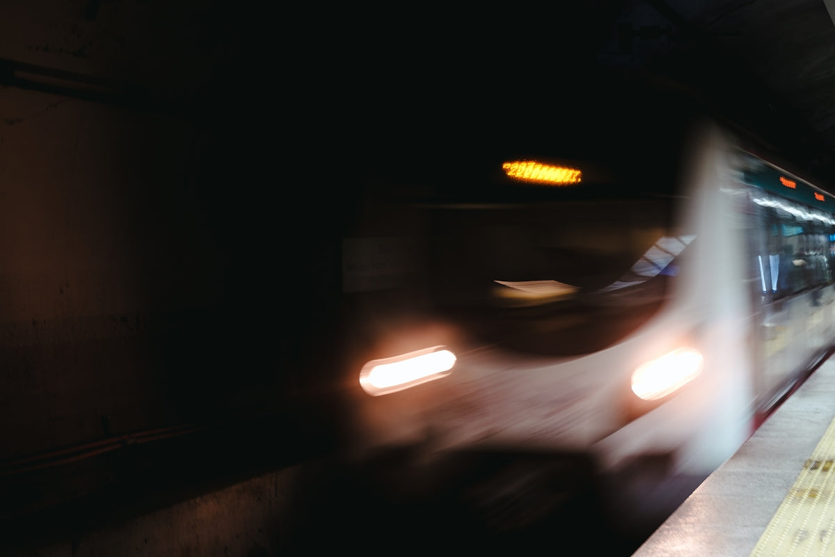 A blurry photo of a subway train at night