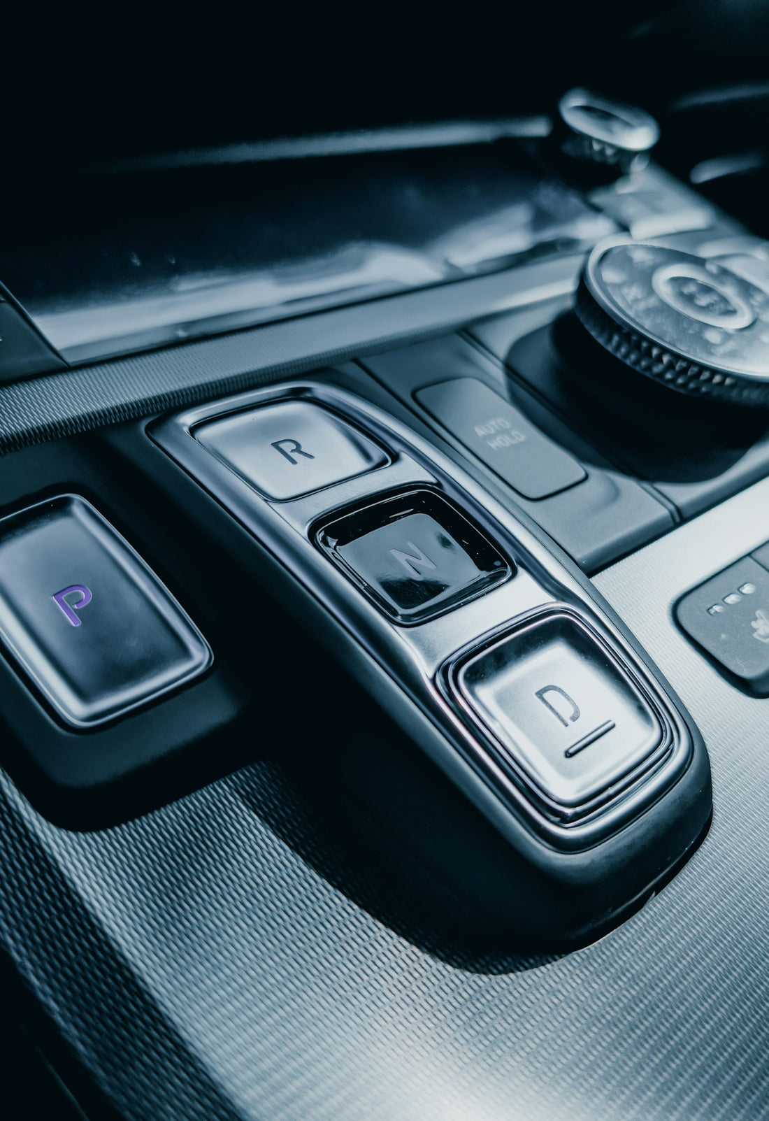 Car's gearshift console and controls are shown.