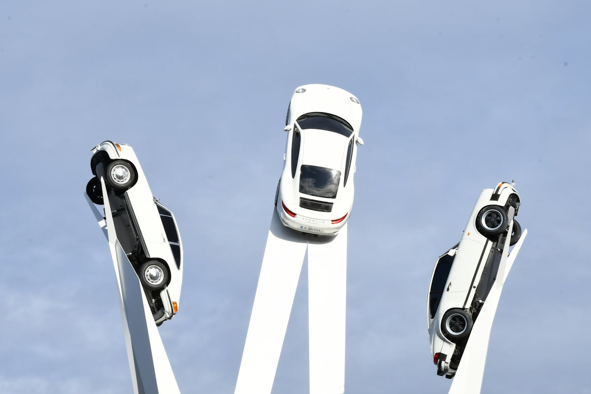 Three white cars are mounted in a circle.