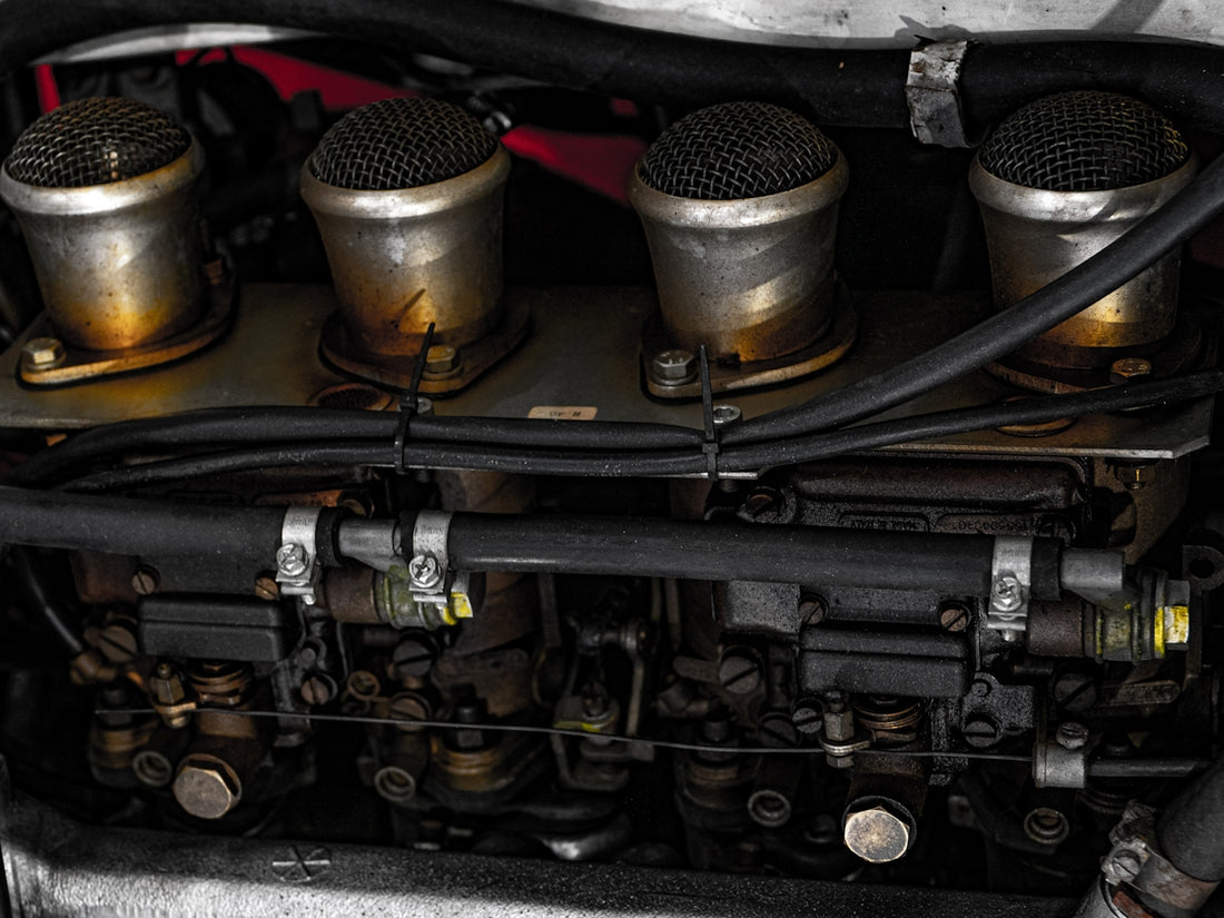 Here's a caption: an engine's carburator in detailed view.