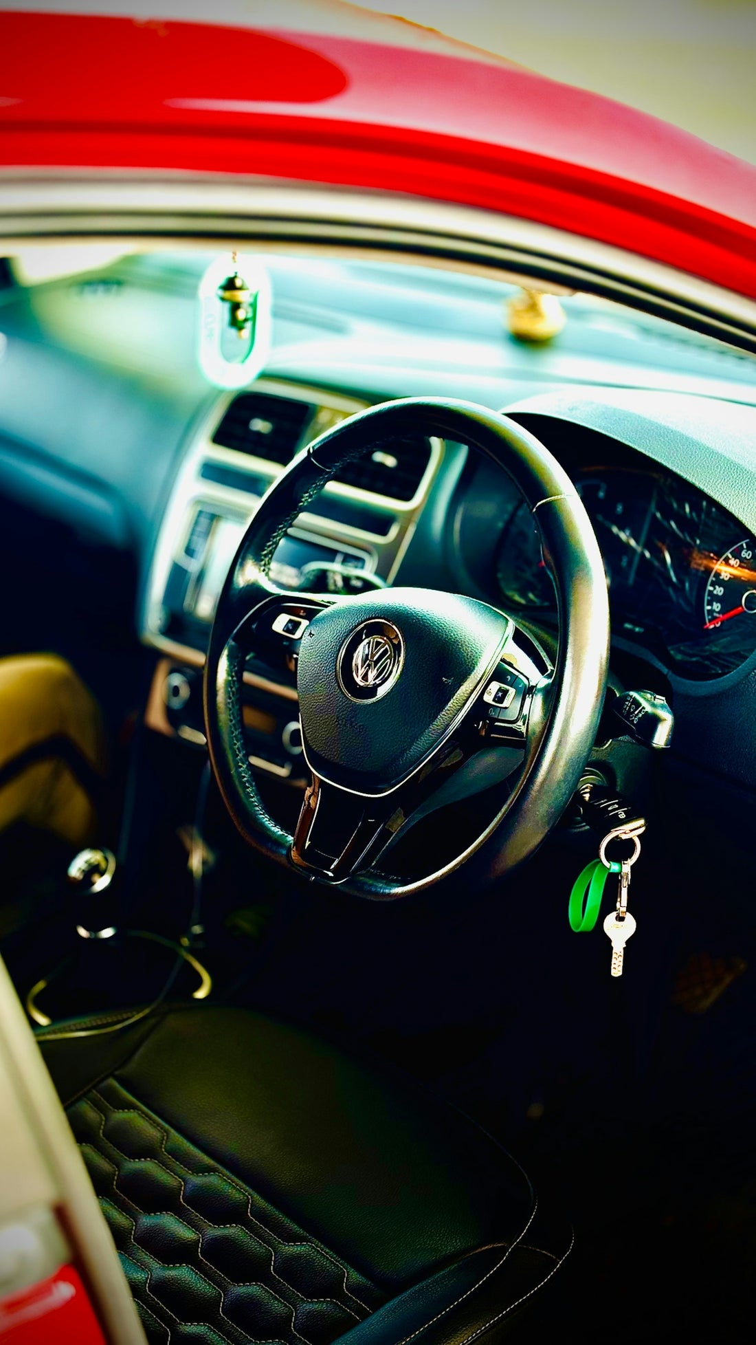 Car interior with steering wheel and seat.