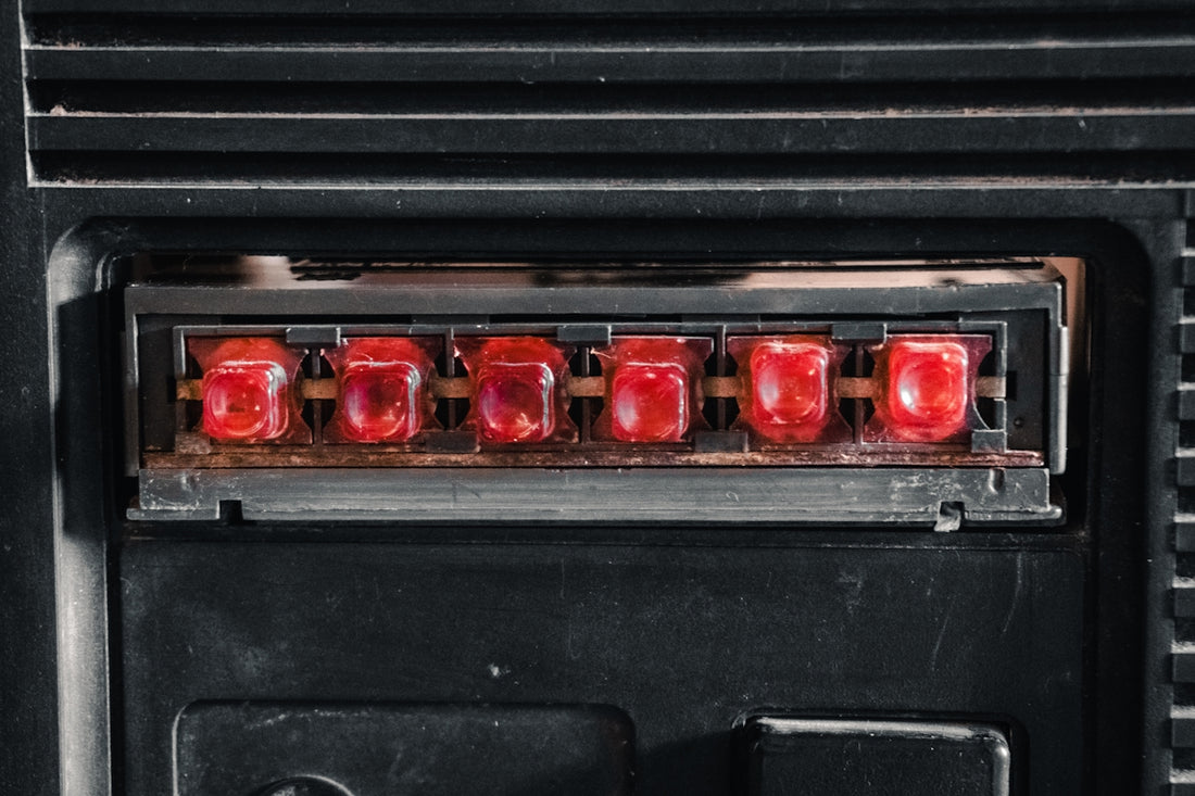 Close-up of six red indicator lights on black panel